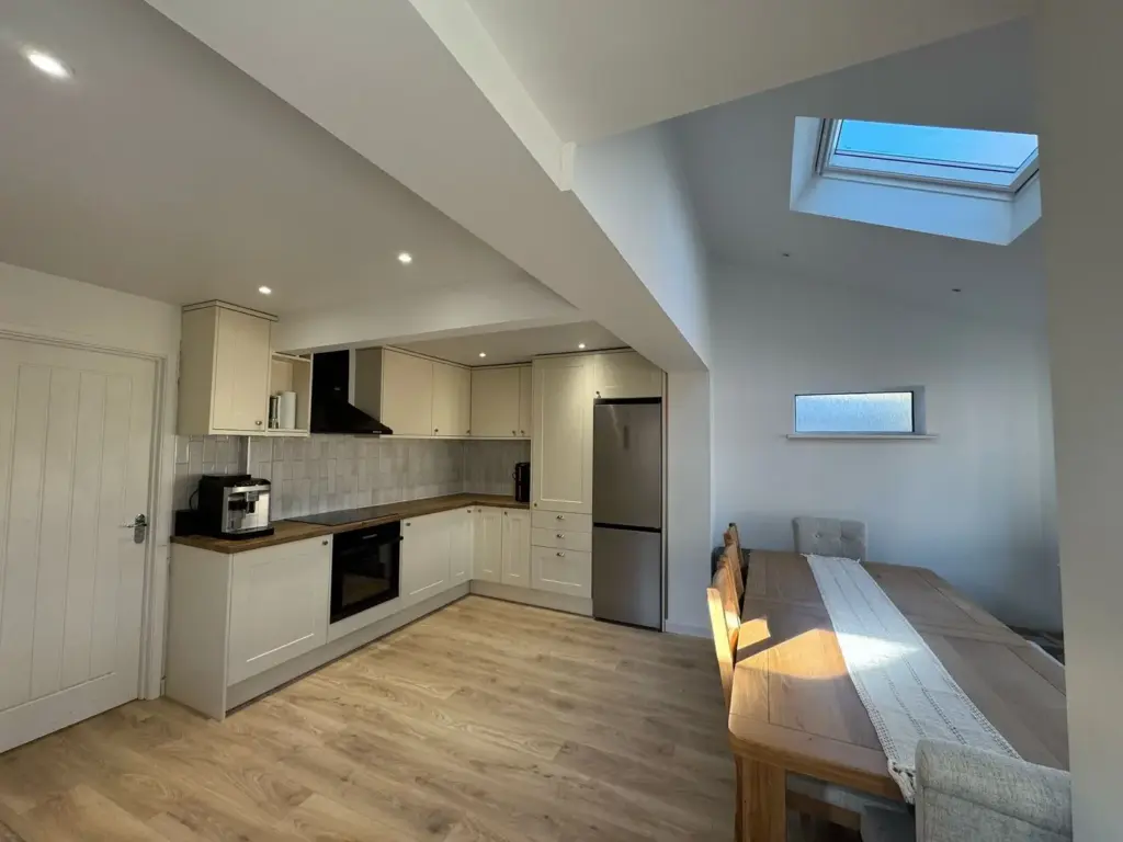 bespoke kitchen installation with skylight and modern fitted units