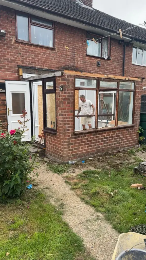 house extension builders surrey working on brick rear extension exterior
