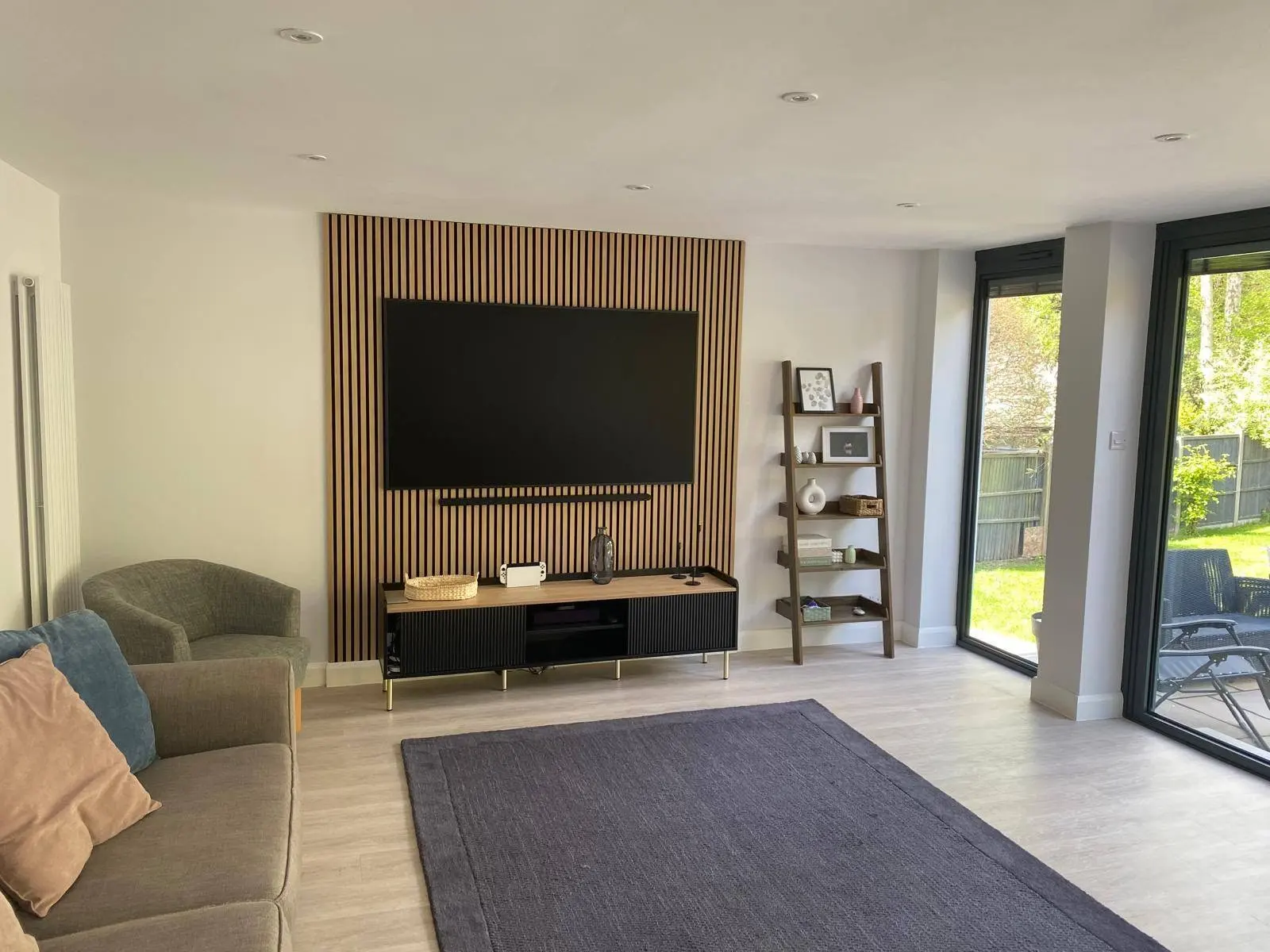 house renovation in woking with open-plan living area and media wall