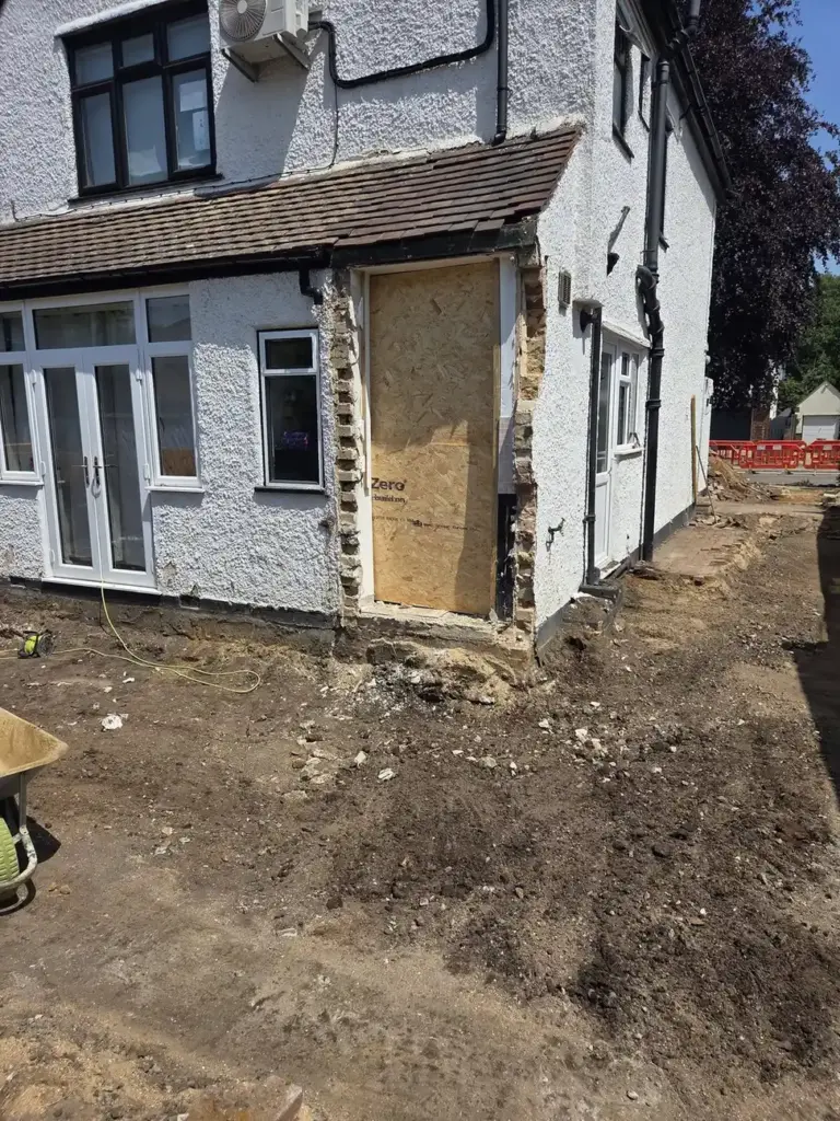 Harpers Home Developments 66 excavation work beside a house during property groundworks.