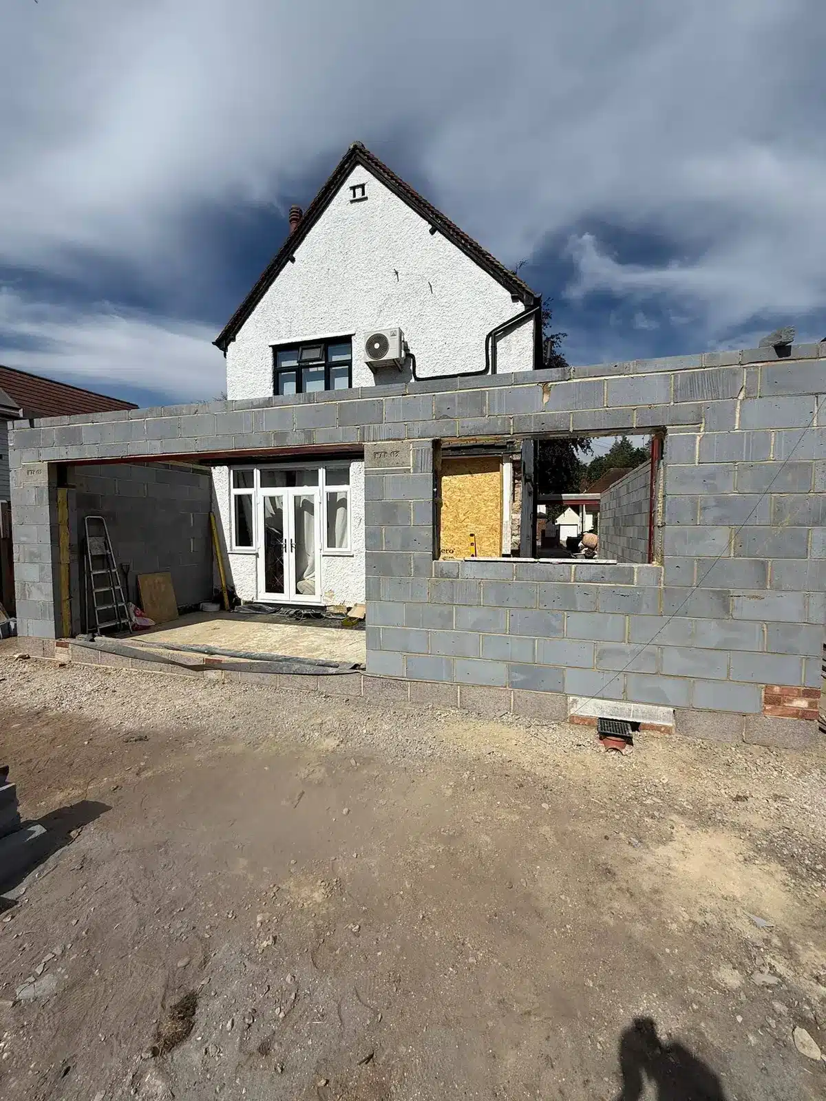 Rear house extension under construction with blockwork walls.