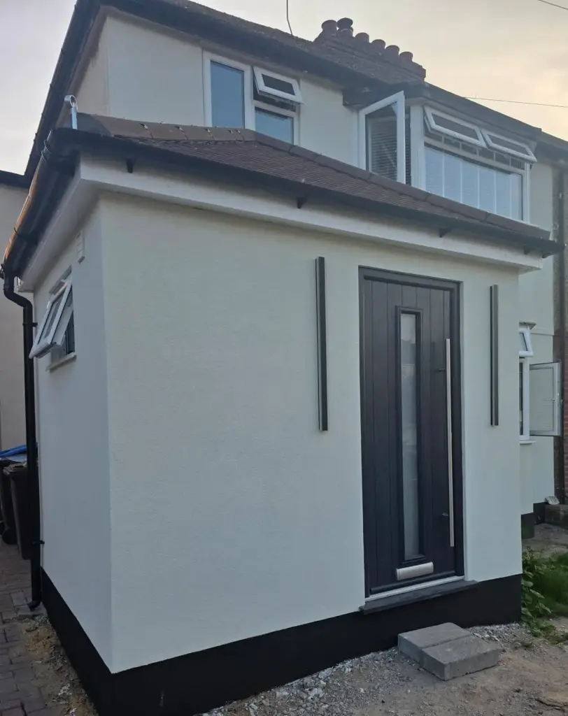 Projects 10 side view of finished rendered house extension.