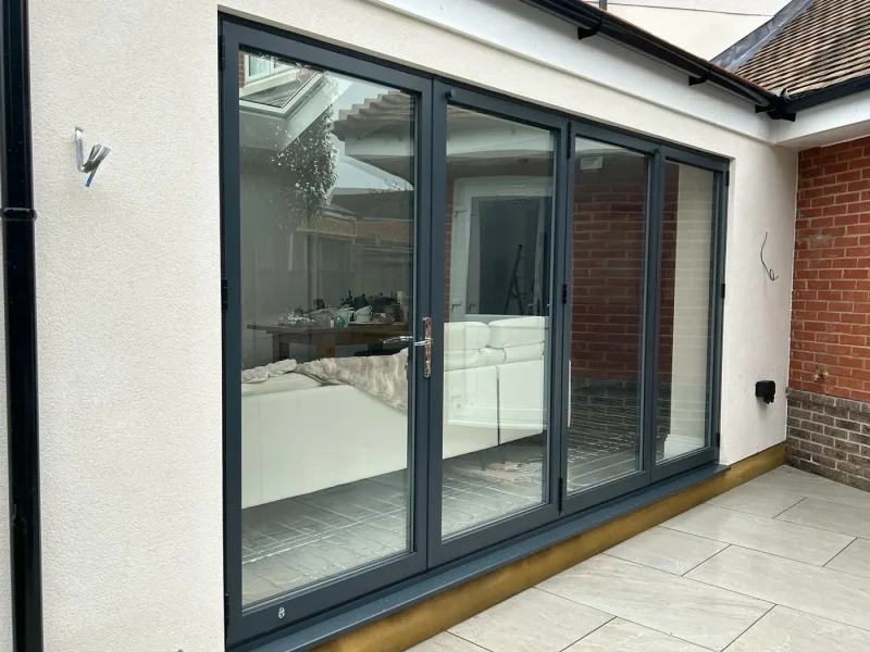 new build contractors in surrey installing modern sliding glass doors